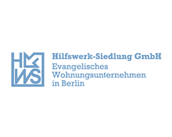 Das Logo von Hilfswerk-Siedlung GmbH zeigt den Schriftzug in blauer Schrift auf hellem Hintergrund, mit einem modernen Design.